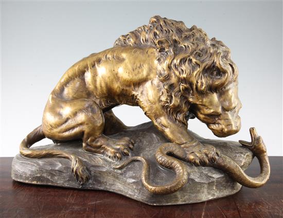 An Austrian cold painted terracotta figure group modelled as a lion and snake, 19in.